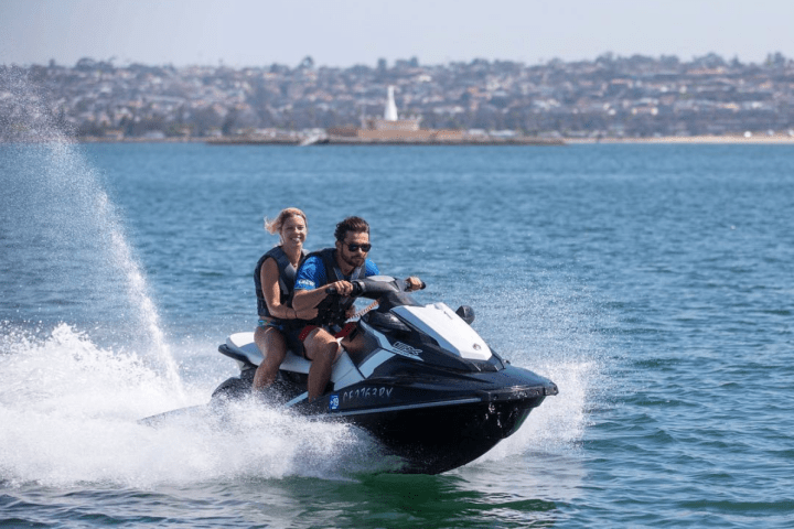 Jetskiers riding through water