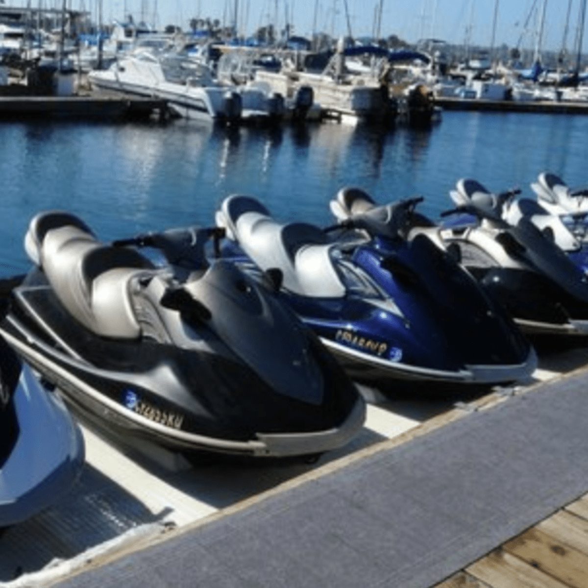 row of jet skis lined up at dock