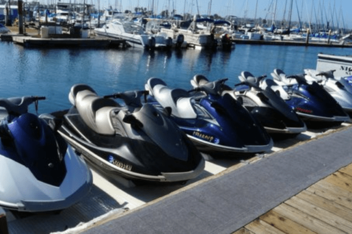 row of jet skis lined up at dock