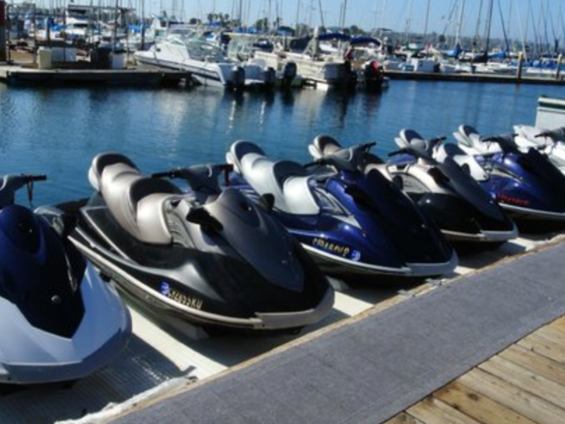 row of jet skis lined up at dock
