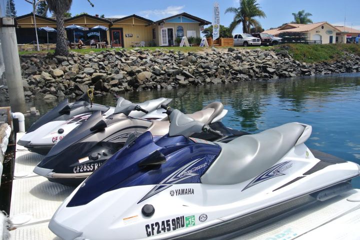 jet skis tied up by dock
